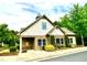 Exterior view of clubhouse building with stone and shake siding and manicured landscaping at 114 Constitution Dr, Durham, NC 27705