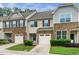 Townhome exterior features stone accents, attached garages, and well-maintained landscaping at 114 Constitution Dr, Durham, NC 27705