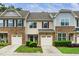 Townhome exterior features stone accents, attached garages, and well-maintained landscaping at 114 Constitution Dr, Durham, NC 27705