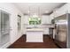Modern kitchen with white cabinetry, stainless steel appliances, and a granite island, perfect for entertaining at 114 Constitution Dr, Durham, NC 27705