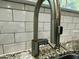 Modern stainless steel kitchen sink with granite countertop and white subway tile backsplash, combining style and practicality at 114 Constitution Dr, Durham, NC 27705
