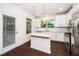 Well-lit kitchen with white cabinets, granite countertops, and stainless steel appliances, offering style and functionality at 114 Constitution Dr, Durham, NC 27705