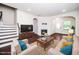 Bright living room featuring a fireplace, hardwood floors and neutral furniture arrangement at 114 Constitution Dr, Durham, NC 27705
