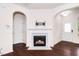 Living room showcases a charming fireplace with white mantle, arches, and hardwood floors at 114 Constitution Dr, Durham, NC 27705