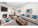 Bright living room featuring a fireplace, hardwood floors, neutral furniture and decor at 114 Constitution Dr, Durham, NC 27705