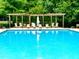 Relaxing community pool features ample seating, a pergola and crystal-clear blue water at 114 Constitution Dr, Durham, NC 27705