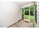 Covered porch with screened entry door and view of the backyard at 114 Constitution Dr, Durham, NC 27705