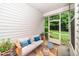 Cozy covered porch features outdoor seating and view of green backyard at 114 Constitution Dr, Durham, NC 27705