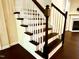 Elegant staircase features dark wood treads and white risers, adding a touch of sophistication to the home's interior at 114 Constitution Dr, Durham, NC 27705