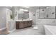 Beautiful bathroom featuring double vanity, a soaking tub, and luxurious glass enclosed shower at 117 Arborhill Ln, Holly Springs, NC 27540