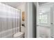 Cozy bathroom featuring toilet and a view of the bedroom at 117 Arborhill Ln, Holly Springs, NC 27540