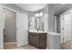 Neutral bathroom with cabinets and a view of the toilet room and closet room at 117 Arborhill Ln, Holly Springs, NC 27540