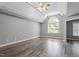 Spacious bedroom with vaulted ceilings, fan, and hardwood floors at 117 Arborhill Ln, Holly Springs, NC 27540