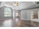 Large bedroom with tray ceilings, hardwood floors and a large window at 117 Arborhill Ln, Holly Springs, NC 27540