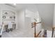 Hallway featuring built-in bookshelves and a view of the stairway at 117 Arborhill Ln, Holly Springs, NC 27540