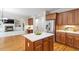 Modern kitchen with a breakfast bar island, stainless steel appliances, and open floor plan at 117 Arborhill Ln, Holly Springs, NC 27540