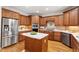 Spacious kitchen featuring stainless steel appliances, an island with seating, and stylish cabinetry at 117 Arborhill Ln, Holly Springs, NC 27540