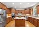 Gourmet kitchen with stainless steel appliances, center island, custom backsplash and ample cabinet space at 117 Arborhill Ln, Holly Springs, NC 27540