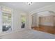 Carpeted living room with multiple windows and access to dining room, providing plenty of natural light and an open flow at 117 Arborhill Ln, Holly Springs, NC 27540