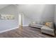 Comfortable living room featuring hardwood floors, gray paint, and a gray sofa with decorative pillows at 117 Arborhill Ln, Holly Springs, NC 27540
