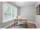 Bright office with natural light and hardwood floors, and modern desk at 117 Arborhill Ln, Holly Springs, NC 27540