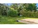 Lush green backyard with mature trees and a patio area at 118 Brandi Dr, Rolesville, NC 27571
