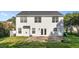 Back exterior of a two-story home with a patio and spacious backyard surrounded by greenery at 118 Brandi Dr, Rolesville, NC 27571