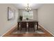 Cozy dining room featuring a wooden table, four chairs, decorative lighting, and neutral walls at 118 Brandi Dr, Rolesville, NC 27571