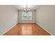 Empty room with hardwood floors, a large window, and neutral walls ready for customization at 118 Brandi Dr, Rolesville, NC 27571