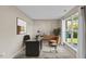 Bright home office featuring a modern desk, comfortable seating, and large window with natural light at 118 Brandi Dr, Rolesville, NC 27571