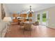 Open kitchen with center island, stainless appliances, and adjacent dining area with doors to the backyard at 118 Brandi Dr, Rolesville, NC 27571