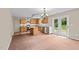 Open kitchen with central island, stainless appliances, and access to back yard at 118 Brandi Dr, Rolesville, NC 27571