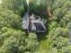 Aerial view of house featuring a long driveway and surrounded by lush trees at 1211 New Grissom Way, Wake Forest, NC 27587