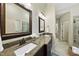 Bathroom featuring double sinks, granite countertop and decorative mirrors and lighting at 1211 New Grissom Way, Wake Forest, NC 27587