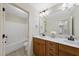 Bathroom features a double sink vanity, granite countertops, a large mirror, and tub-shower combination at 1211 New Grissom Way, Wake Forest, NC 27587