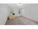 Bedroom featuring two windows for natural light and neutral carpet flooring at 1211 New Grissom Way, Wake Forest, NC 27587