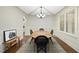 Elegant dining room featuring coffered ceiling, wainscoting, and modern light fixture at 1211 New Grissom Way, Wake Forest, NC 27587