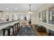 An elegant dining room featuring hardwood floors, a decorative rug, and large windows at 1211 New Grissom Way, Wake Forest, NC 27587
