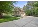 A side view showcasing the home's stone and shingle exterior and attached garage at 1211 New Grissom Way, Wake Forest, NC 27587