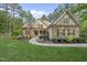 Charming home featuring a stone facade, manicured lawn, and inviting walkway at 1211 New Grissom Way, Wake Forest, NC 27587