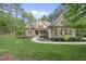 Inviting two-story home boasts stone accents, manicured lawn and mature trees at 1211 New Grissom Way, Wake Forest, NC 27587