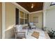 Cozy seating area on the covered front porch with view of front yard at 1211 New Grissom Way, Wake Forest, NC 27587