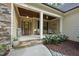 Charming covered front porch featuring stone accents, wooden ceiling and sitting area at 1211 New Grissom Way, Wake Forest, NC 27587