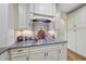 Kitchen featuring gray granite countertops, white cabinets, and a gas range at 1211 New Grissom Way, Wake Forest, NC 27587