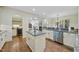 Bright kitchen with gray countertops, an island, and stainless steel appliances at 1211 New Grissom Way, Wake Forest, NC 27587