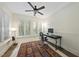 Bright home office with wainscoting, a ceiling fan, and a patterned rug at 1211 New Grissom Way, Wake Forest, NC 27587