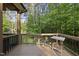 Screened patio with wooded views featuring wood decking and a table for relaxing outdoors at 1211 New Grissom Way, Wake Forest, NC 27587