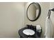 Stylish powder room featuring dark granite countertop and elegant mirror at 1211 New Grissom Way, Wake Forest, NC 27587