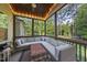 Cozy screened porch with ample seating, a ceiling fan, and wooded views at 1211 New Grissom Way, Wake Forest, NC 27587