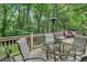 Outdoor deck with table and chairs, perfect for dining and enjoying the wooded view at 123 W Camden Forest Dr, Cary, NC 27518